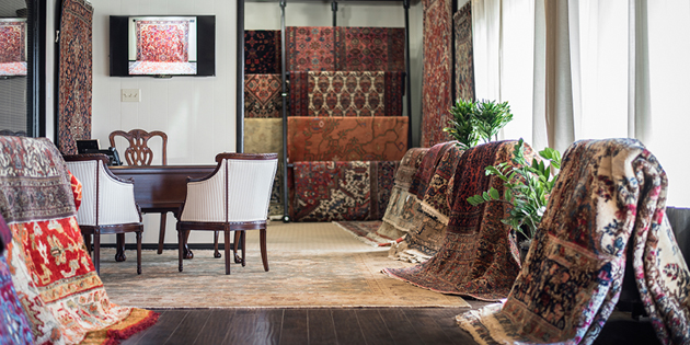 Aladdin Rug Gallery with numerous rugs displayed.