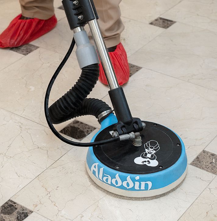 An Aladdin cleaning specialist professionally cleaning tile and grout flooring