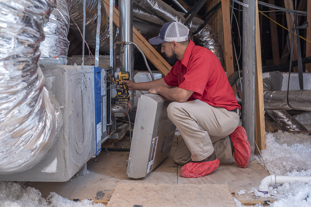 Aladdin cleaning specialist cleans return air duct vent with hand vacuum then inspects and cleans unit
