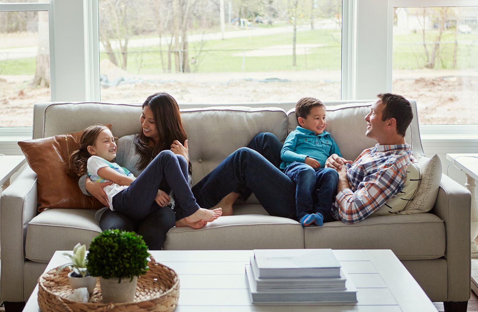 Family sitting on couch in home