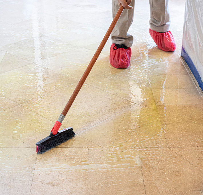 An Aladdin cleaning specialist professionally cleaning stone flooring
