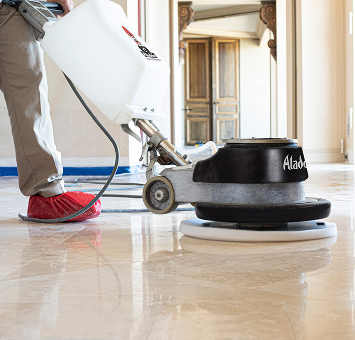 Aladdin cleaning specialist using polishing pads & powders to achieve high gloss finish to professionally cleaned stone floor
