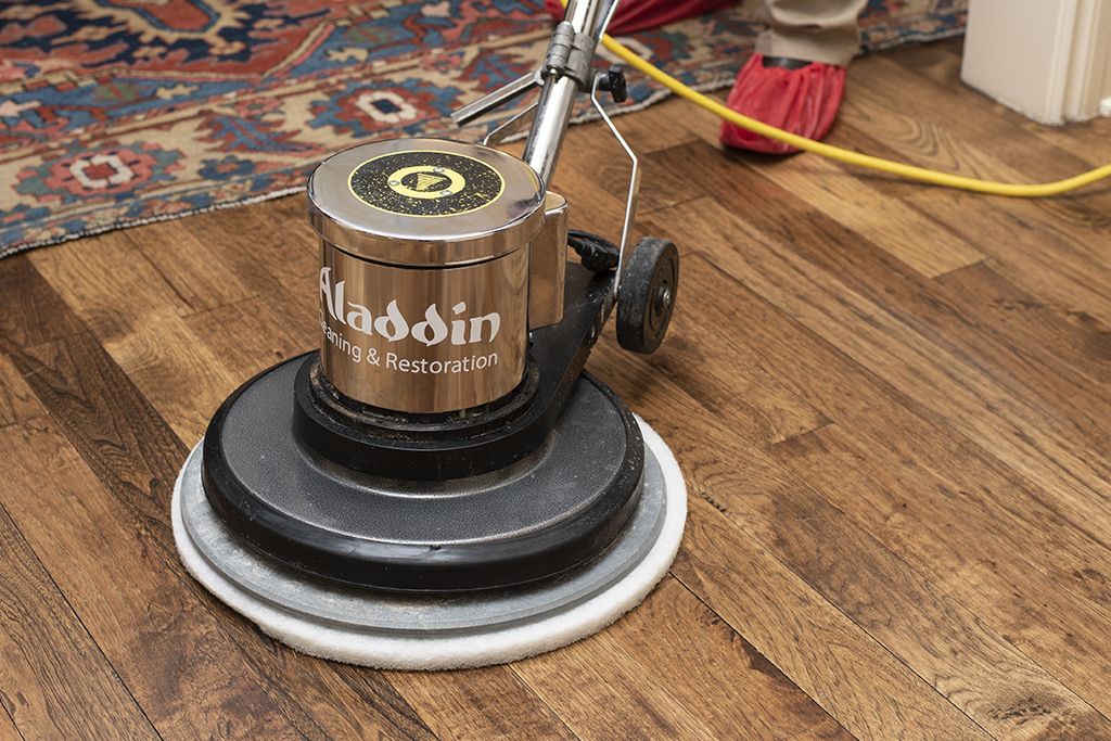 Aladdin cleaning specialist professionally cleaning hard wood floor