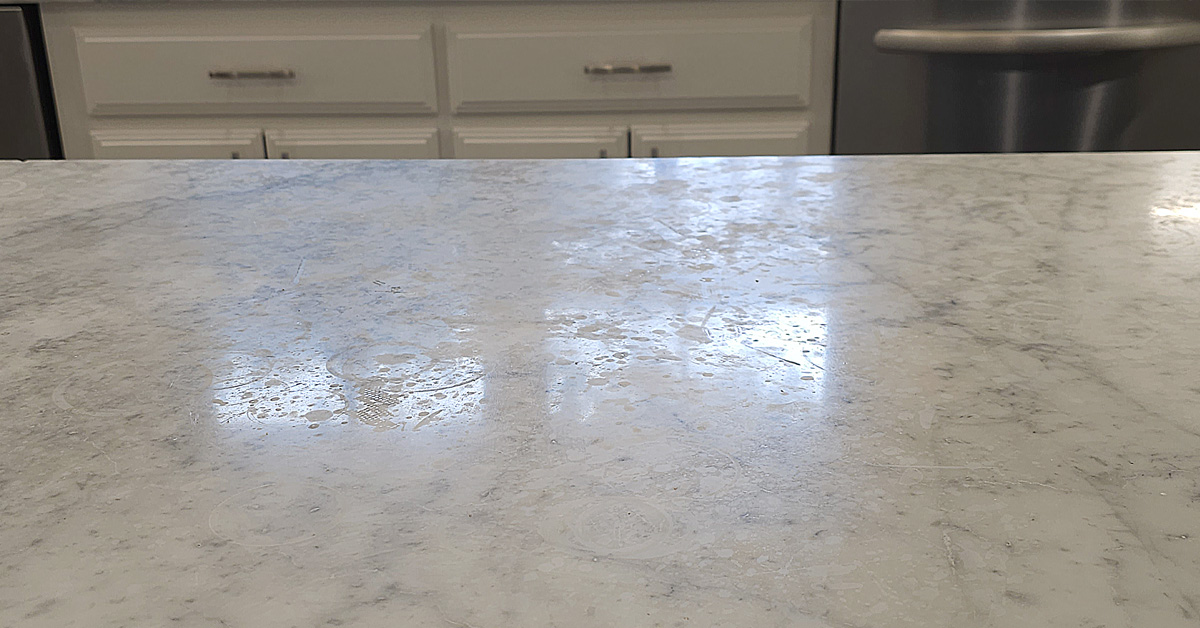 Etching damage on white marble countertop