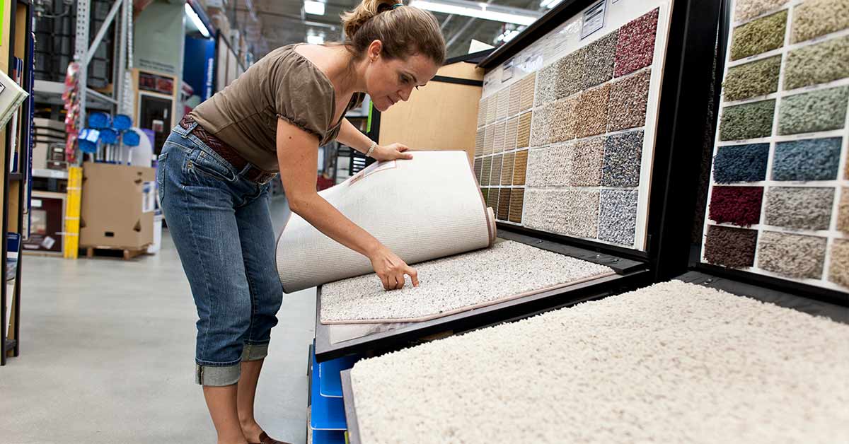 woman picking out new carpet how to pick new carpet for home