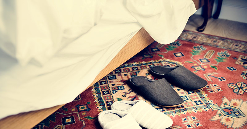 An oriental rug placed under a bed
