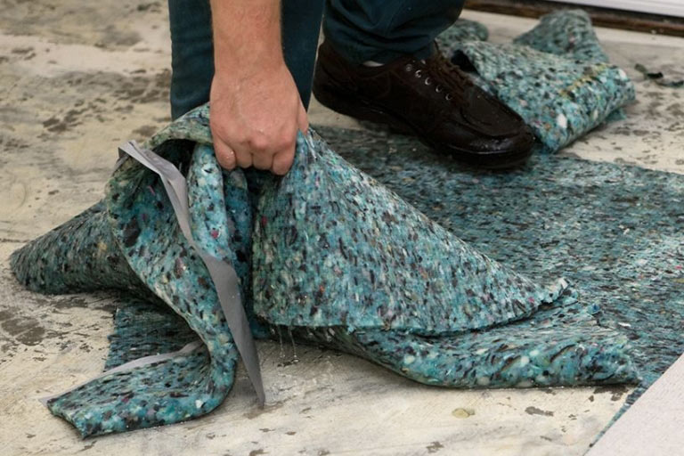 An Aladdin cleaning specialist applies industry-leading fabric protection to an oriental rug